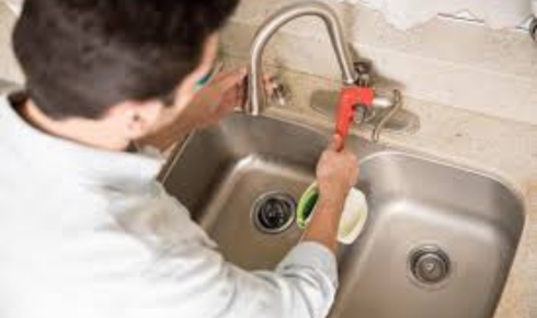 How can checking under sinks for tiny drops or stains catch leaks before they grow